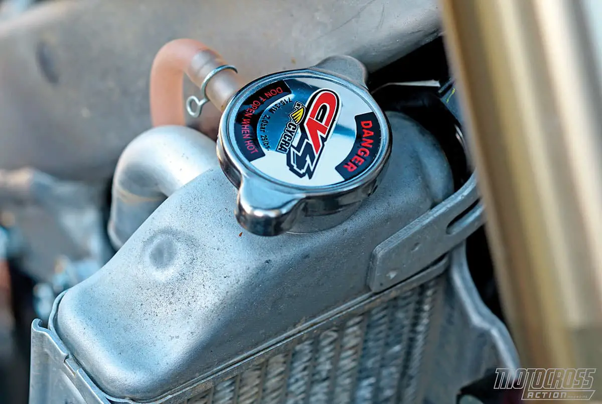 Job number one on any bike with a 1.1 kg/cm2 radiator cap is to replace it with a high-pressure cap. This CV4 cap is 2.0 kg/cm2.